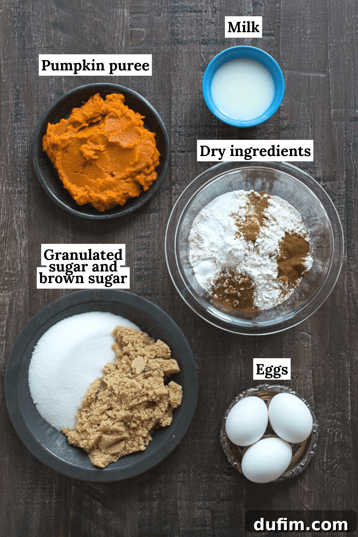 This Pumpkin Pound Cake recipe tastes just like Starbucks Pumpkin Pound Cake - takes 15 minutes to prep! Can be made in muffin, mini muffin or mini loaf pans. A flat lay shot of the 12 essential ingredients needed to make easy pumpkin bread, neatly arranged on a dark background. Ingredients include flour, sugars, spices, eggs, milk, and canned pumpkin puree.