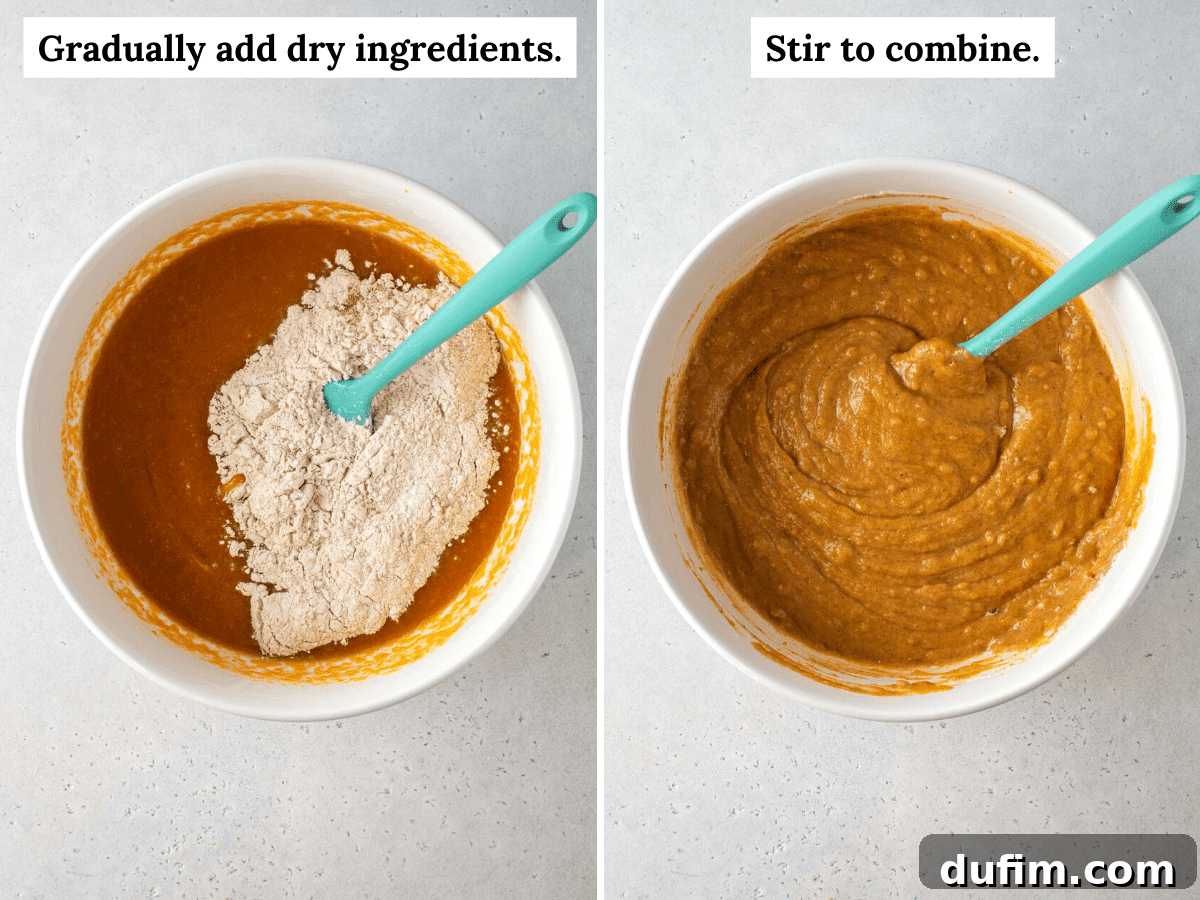 Starbucks Inspired Pumpkin Bread Perfection 4 Hands gently stirring wet and dry ingredients together in a large mixing bowl, showing the consistency of the pumpkin bread batter before it's poured into the pan.