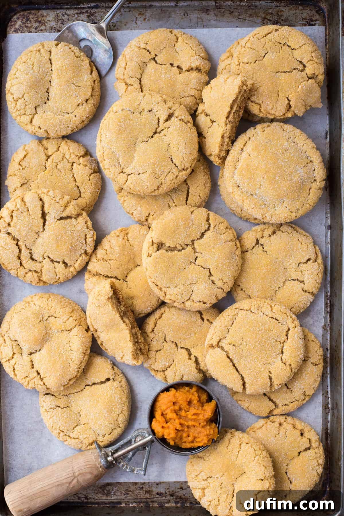 Cozy Pumpkin Cookie Bliss 9 pumpkin cookies randomly arranged on metal baking sheet with white parchment paper