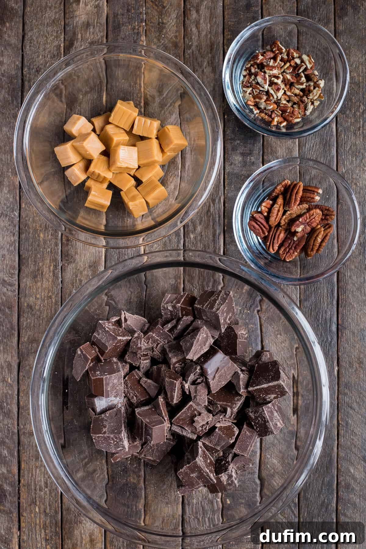 Ingredients to make turtle bark in glass bowls on dark wood background