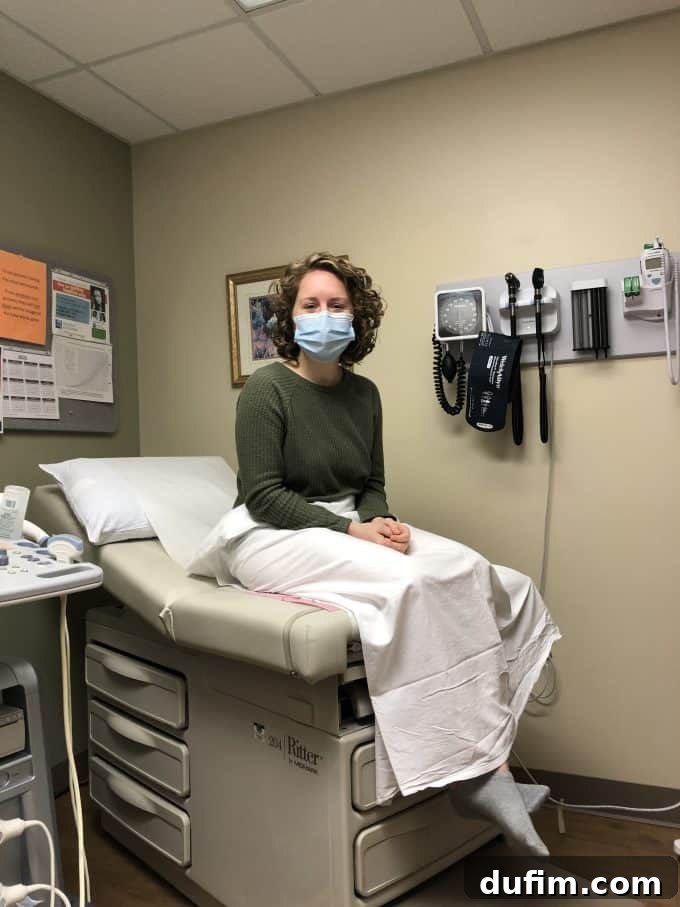 Author and partner at their first prenatal appointment, smiling