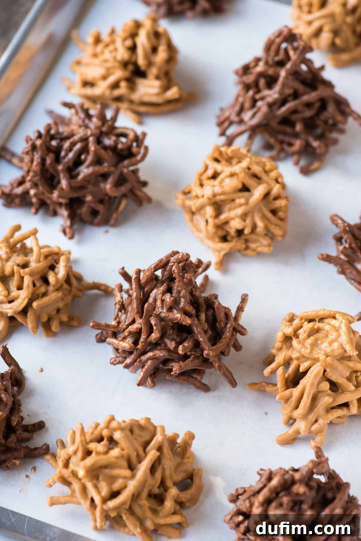 butterscotch haystack cookies and chocolate haystack cookies arranged on brown parchment paper