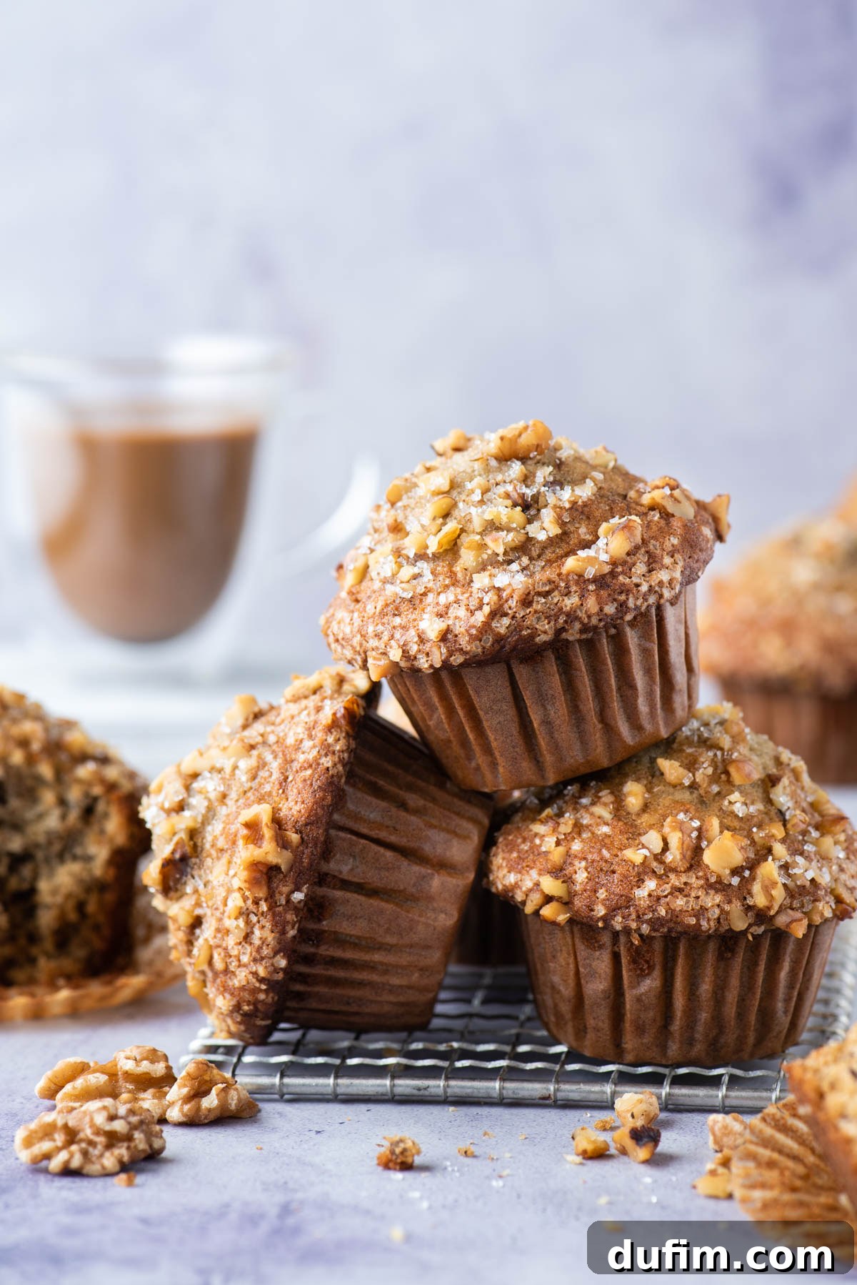 banana nut muffins stacked in a pile on wire rack