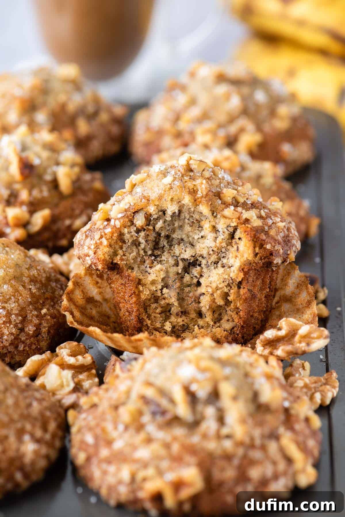 banana muffin in muffin pan with bite removed