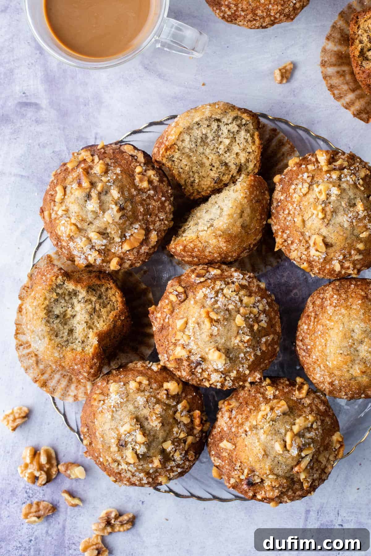 banana nut muffins displayed on glass dish on purple background