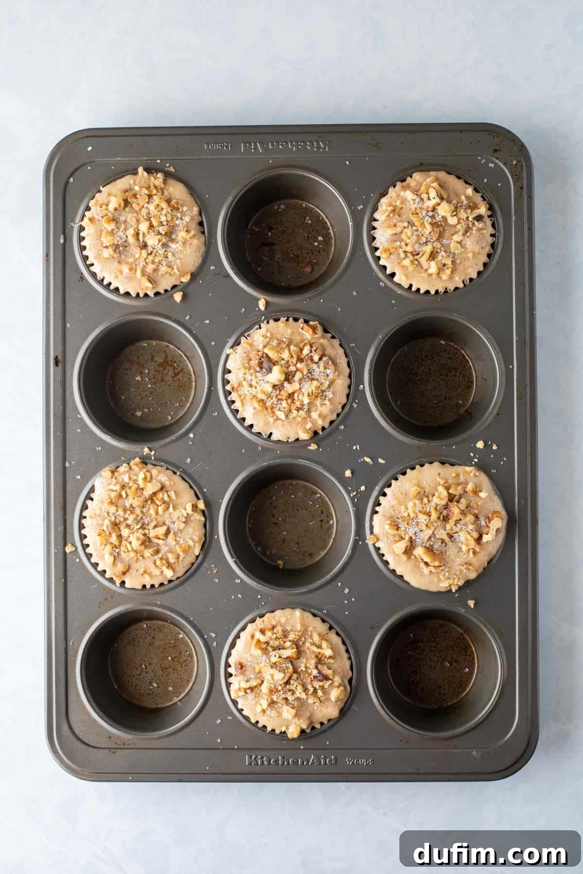banana nut muffin batter in muffin pan
