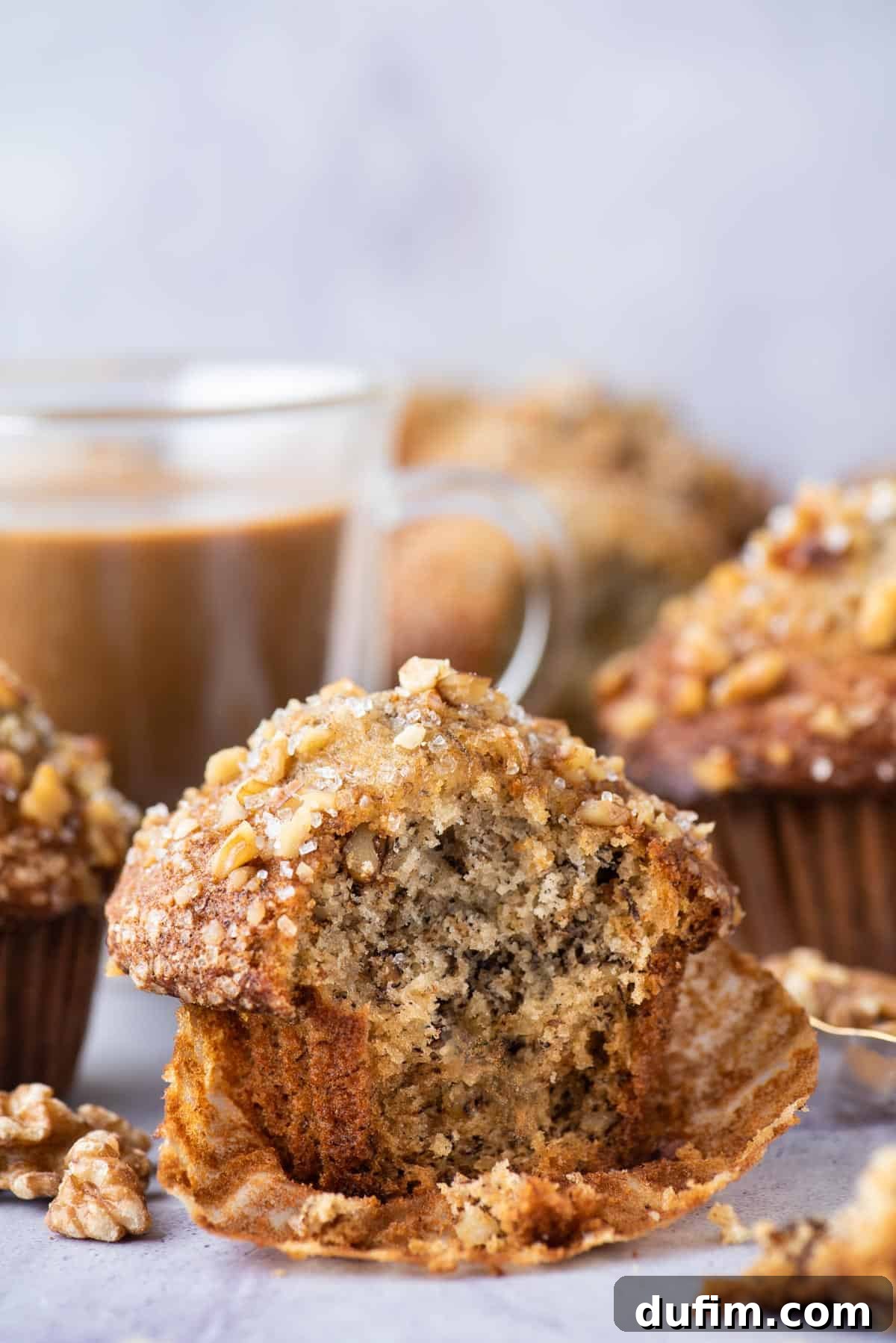 banana nut muffin with bite removed on purple background