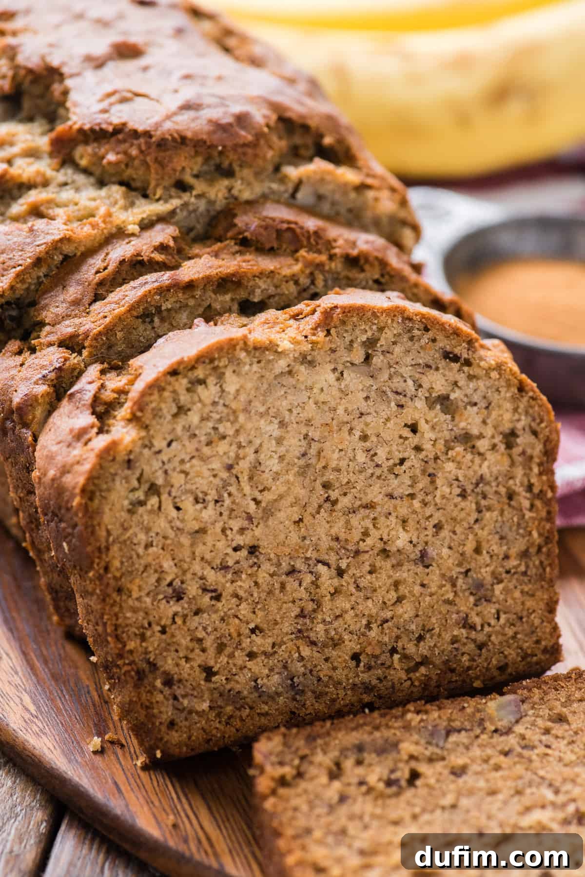 sliced banana bread displayed on wooden cutting board