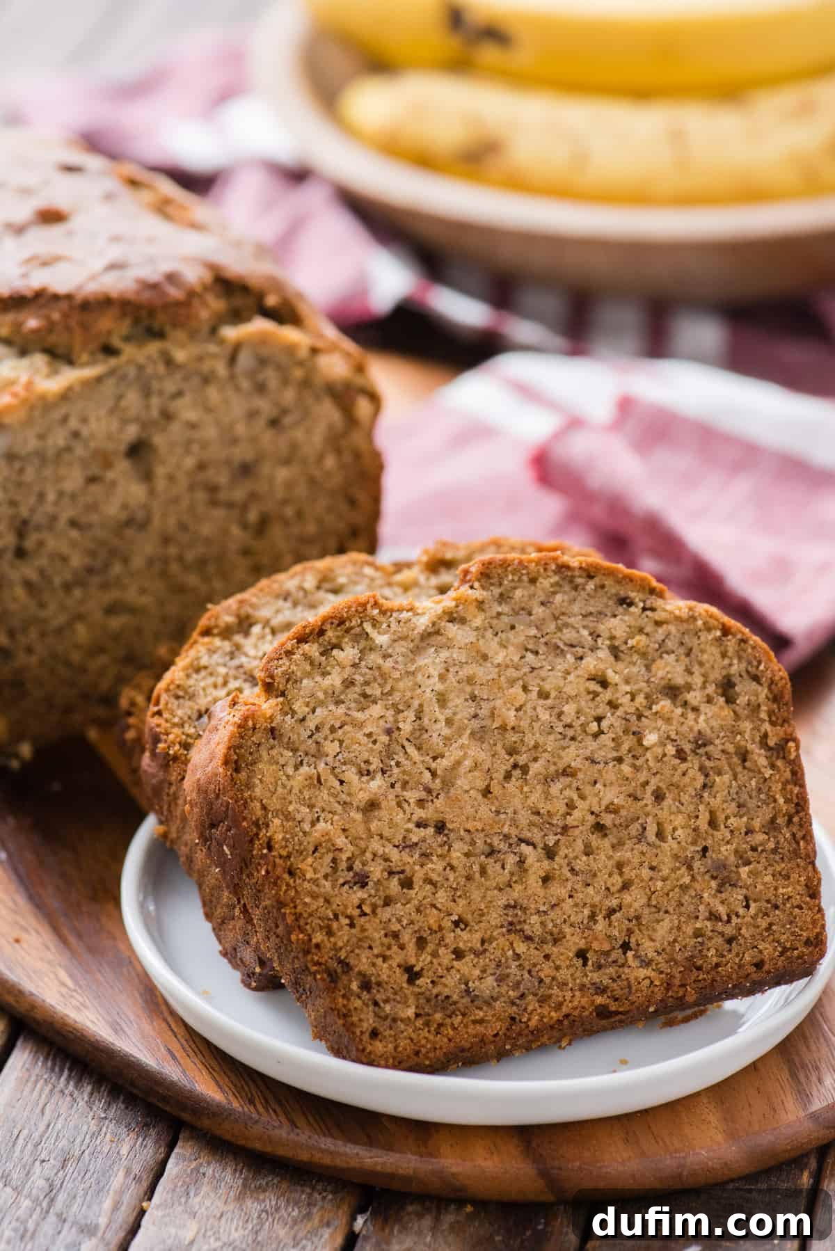 sliced banana bread displayed on wooden cutting board