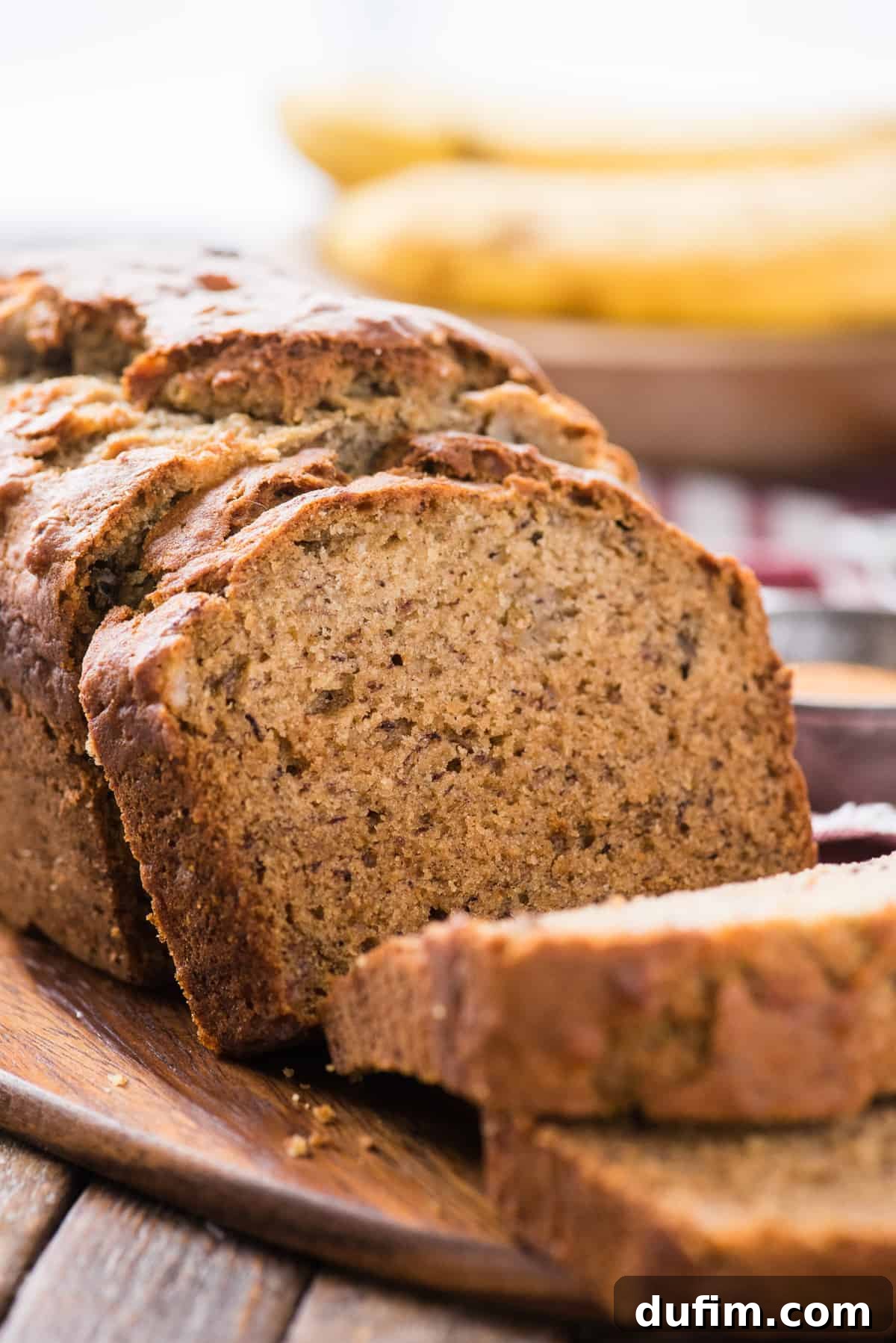 sliced banana bread displayed on wooden cutting board