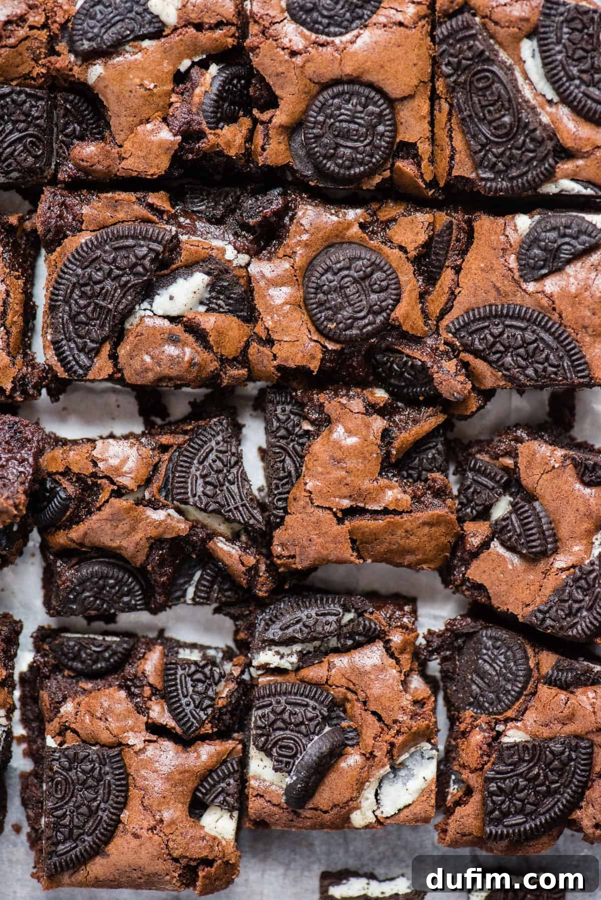 Decadent Oreo Fudge Brownies 8 A close-up shot of several homemade Oreo brownies, perfectly cut into squares and showcasing the delightful texture with visible Oreo cookie pieces baked into the rich chocolate.