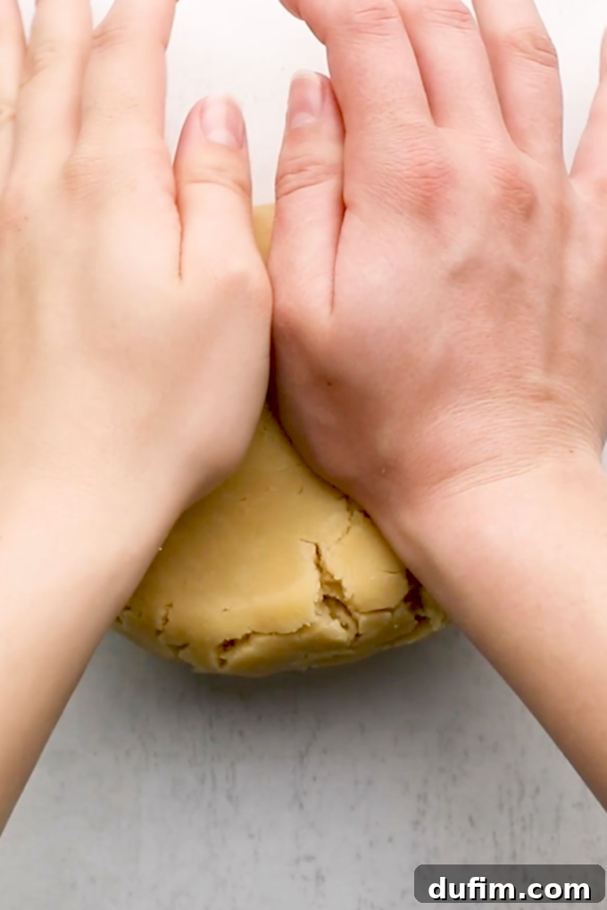 Placing the rolled-out fruit pizza dough onto a baking sheet.