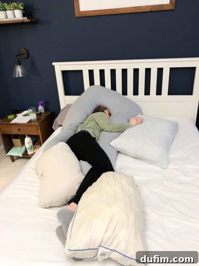 Comfortable pregnancy setup with numerous pillows on a bed, emphasizing the need for support.