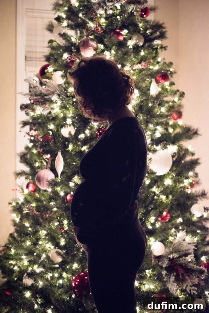 Pregnant woman in a festive setting, showing her 20-week baby bump during Christmas.