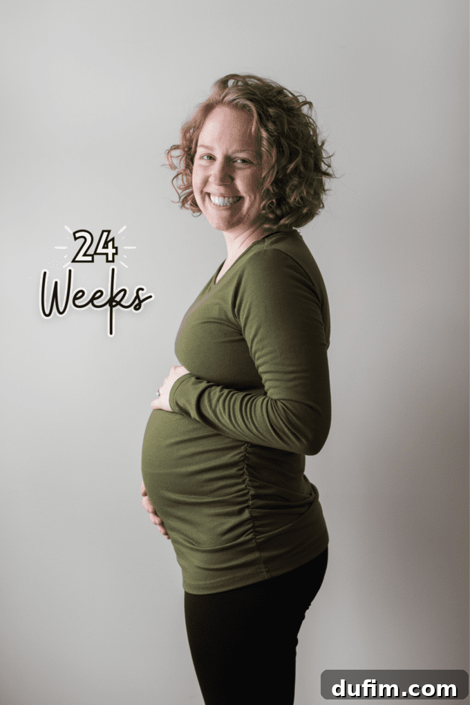 A happy pregnant couple smiling, capturing a moment of anticipation.