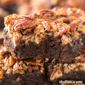 A close-up of decadent pecan pie brownies stacked high, their rich, fudgy centers crowned with chopped pecans and a glossy caramel glaze.