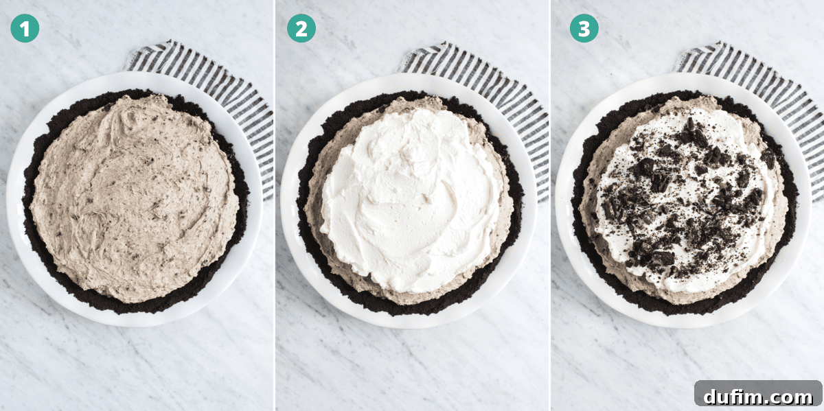 A whole no-bake Oreo pie, freshly topped with generous swirls of whipped cream and a scattering of crushed Oreos, ready to be sliced and enjoyed.