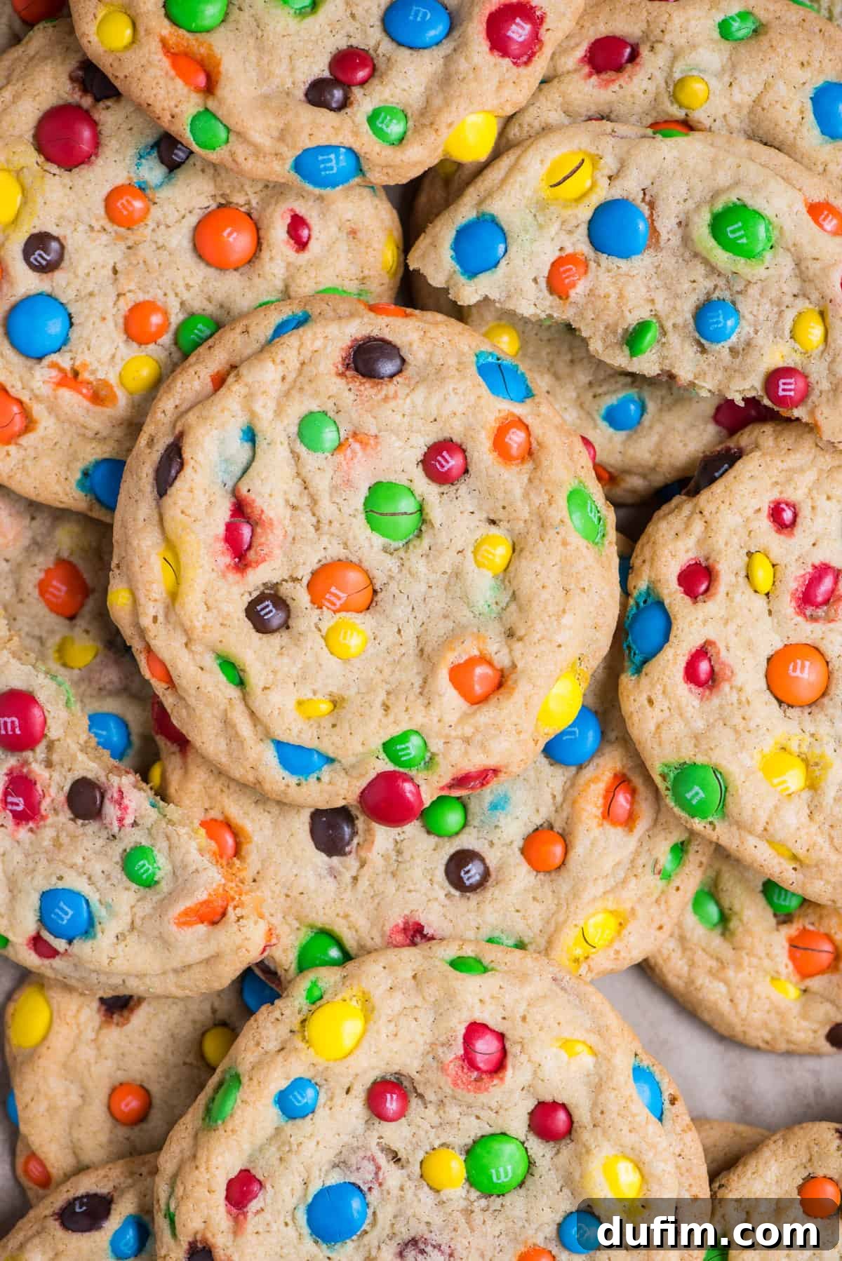 Chewy M&M Cookie Recipe 2 M&M cookies arranged randomly on flat surface, showcasing their colorful candy coating