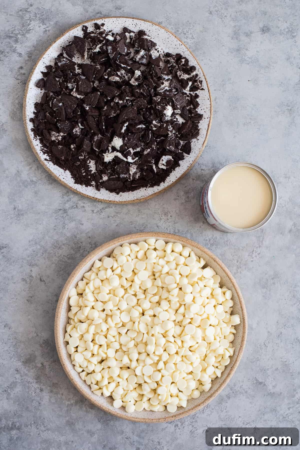 Decadent Oreo Fudge 4 Individual bowls showcasing the simple ingredients needed to make delicious Oreo fudge: sweetened condensed milk, white chocolate chips, chopped Oreos, vanilla extract, and salt