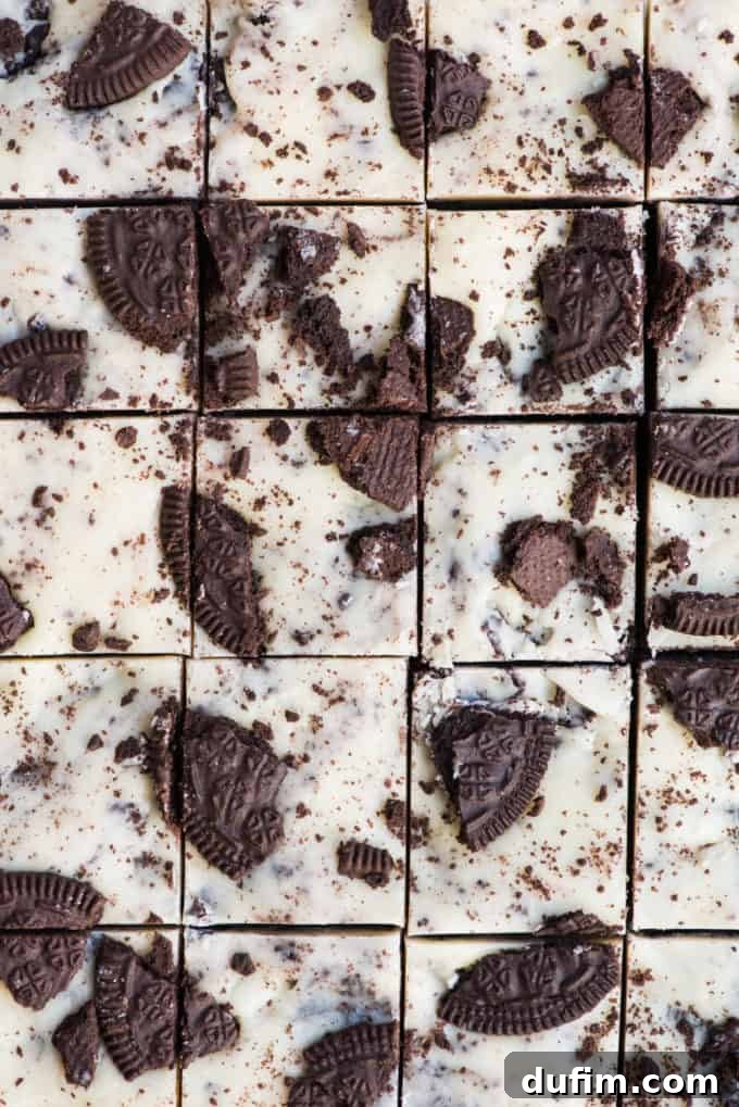 Decadent Oreo Fudge 9 A close-up shot of perfectly cut Oreo fudge squares, ready to be served, highlighting their enticing texture and deliciousness
