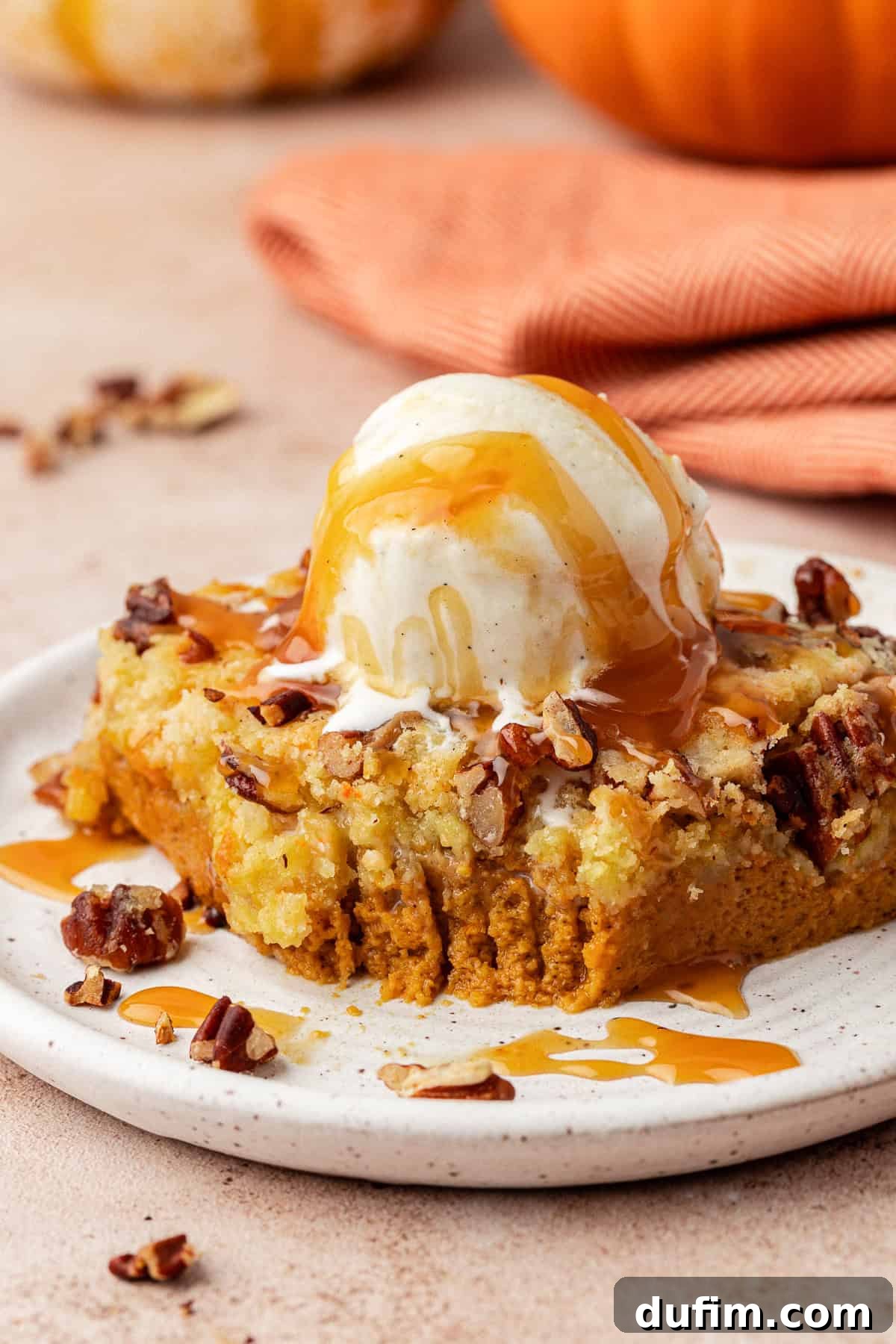 Effortless Autumn Pumpkin Dump Cake 2 A beautifully baked pumpkin dump cake, rich with autumn colors, ready to be served at a festive fall gathering.