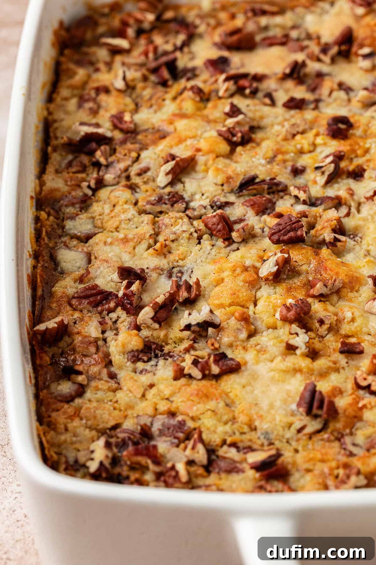 Effortless Autumn Pumpkin Dump Cake 3 A golden-brown pumpkin dump cake, fresh from the oven, showcasing its irresistible crumbly topping and ready to be served.
