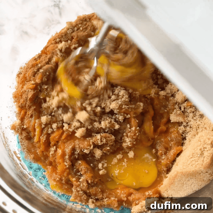 Effortless Autumn Pumpkin Dump Cake 7 Step 1: Combining canned pumpkin puree, evaporated milk, brown sugar, eggs, and pumpkin pie spice in a large mixing bowl.