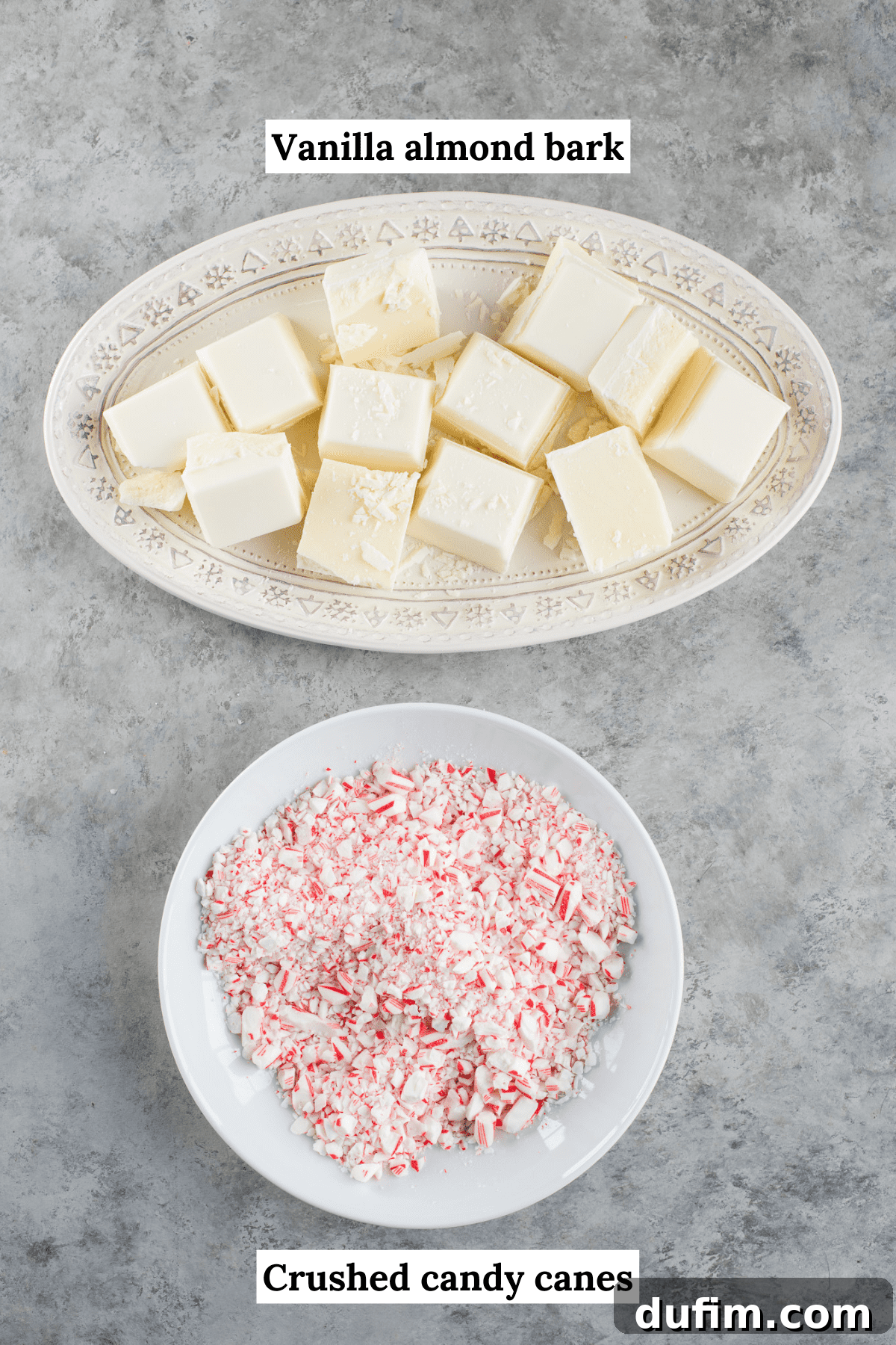 Frosted Peppermint Dream Bark 3 Two white platters displaying ingredients for white chocolate peppermint bark: a bowl of vanilla almond bark and a pile of unwrapped candy canes.