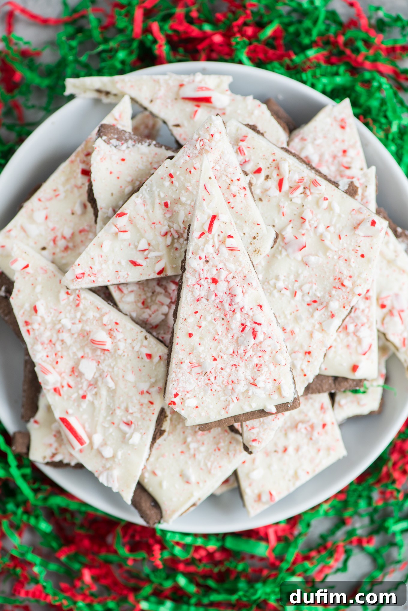 More pieces of chocolate peppermint bark presented on a white plate, emphasizing the simplicity and elegance of this festive treat.
