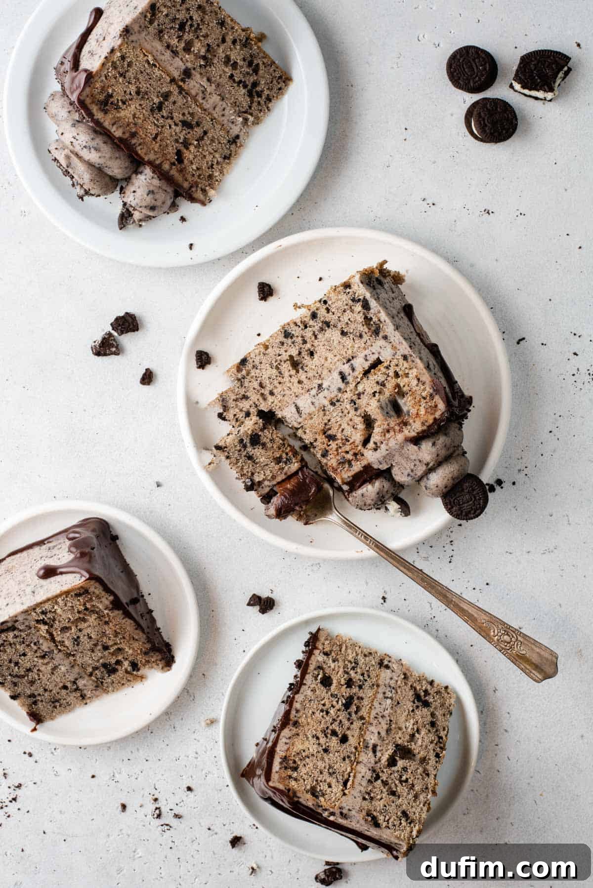 An inviting overhead view of four individual slices of Oreo cake, each beautifully plated and garnished, showcasing the rich layers and tempting frosting.