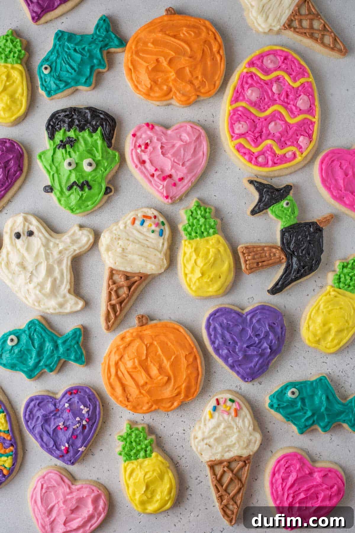 Overhead view of beautifully decorated gluten-free cut-out sugar cookies, showcasing various festive designs and vibrant icing colors, ready for celebration.