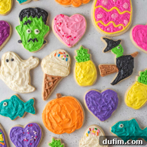 Overhead view of beautifully decorated gluten-free sugar cookies, featuring various colors and sprinkles, arranged appealingly on a white surface.