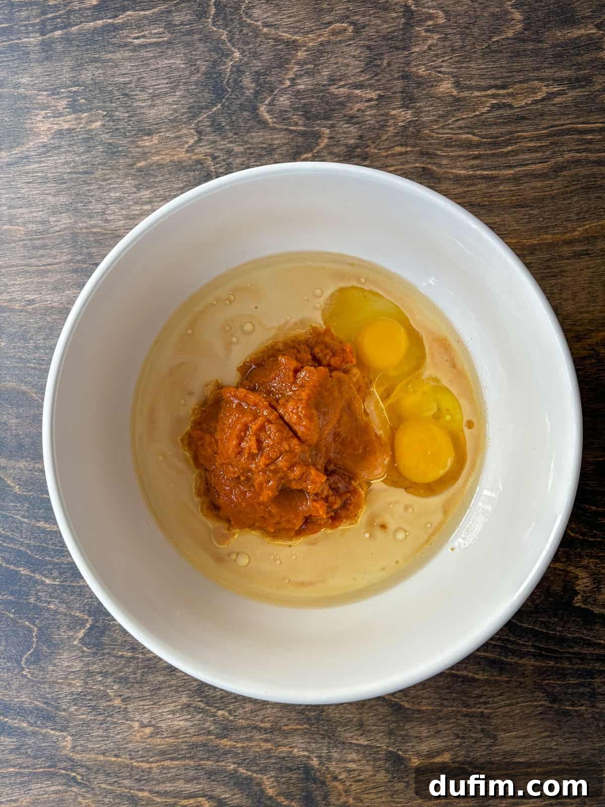 Autumn Spiced Gluten-Free Pumpkin Streusel Muffins 7 Combining wet ingredients in a bowl