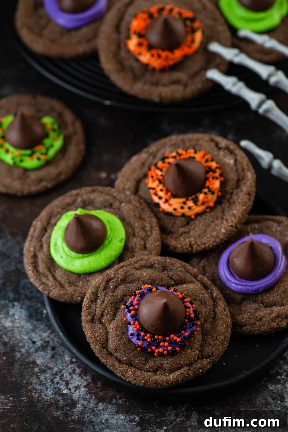 An overhead view capturing the vibrant details of freshly baked Witch Hat Cookies, arranged beautifully on a plate, showcasing their colorful frosting and sprinkle decorations.