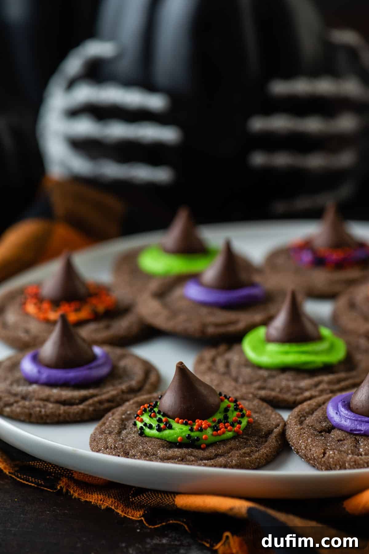 A beautifully arranged plate of finished Witch Hat Cookies, showcasing their charming witch hat designs, colorful frosting, and festive sprinkles.