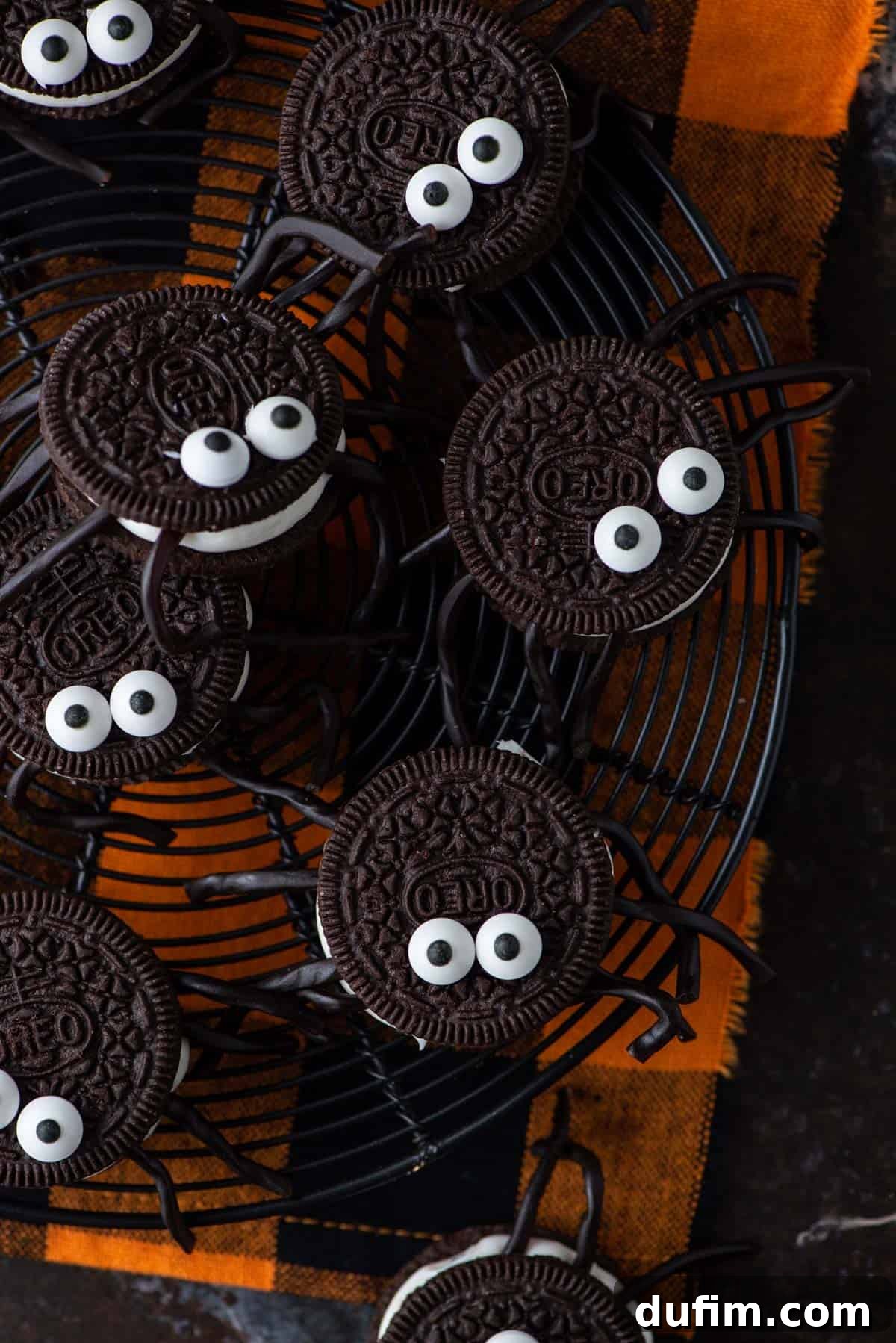 Oreo Spiders - Perfect for Halloween Parties Several Oreo spider cookies arranged on festive orange napkins, ready for a Halloween celebration.