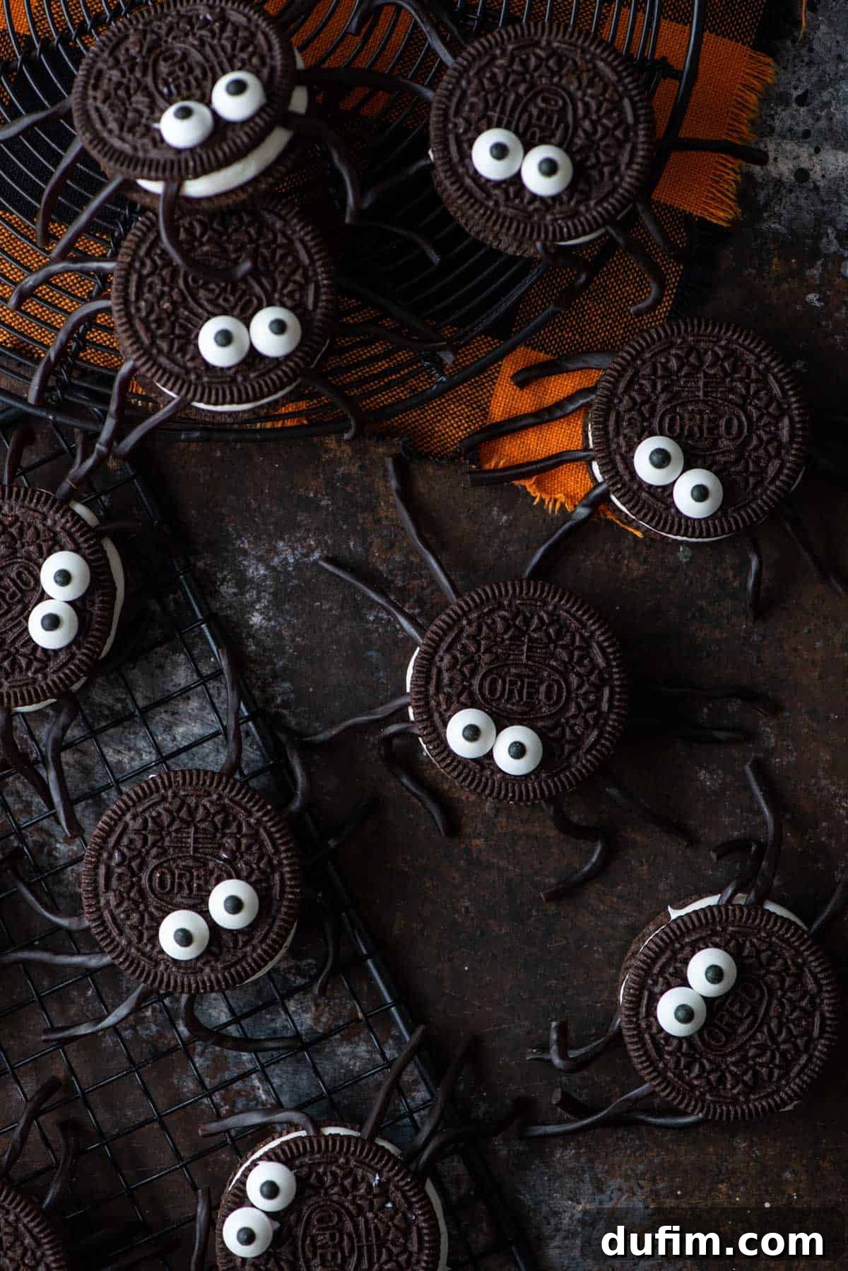 Finished No-Bake Oreo Spiders An overhead view of finished Oreo spiders on a dark background, showcasing their complete look.