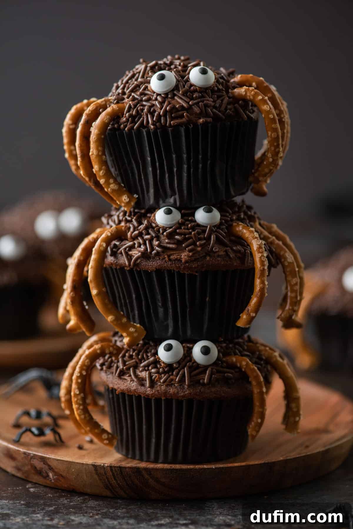 Stacked Spider Cupcakes: A festive tower of Halloween treats. Three perfectly decorated spider cupcakes stacked playfully on top of each other, showcasing their charming details.
