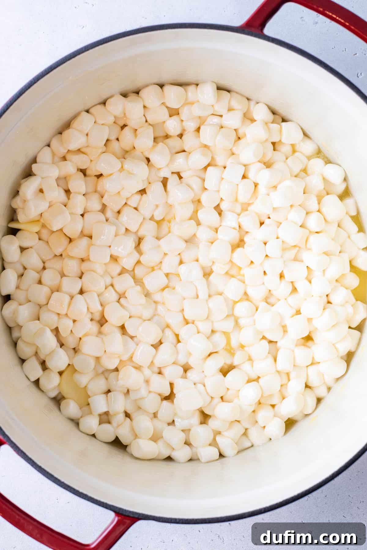 Mini marshmallows and butter beginning to melt in a saucepan over low heat.