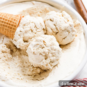 A cone next to three scoops of ice cream in a bowl, highlighting the festive holiday dessert.