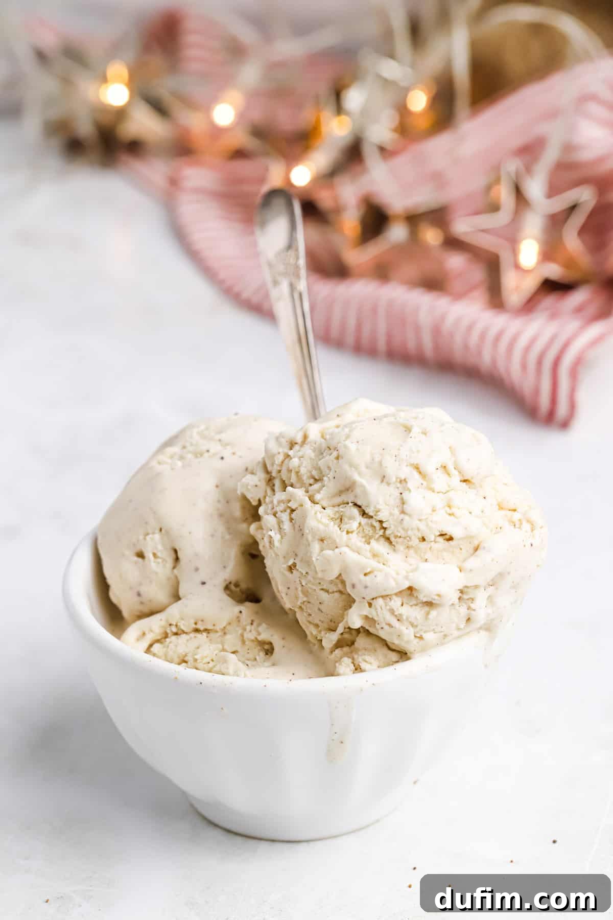 Made with only 6 ingredients, Eggnog Ice Cream is rich, creamy, and perfectly spiced. Perfect for the holidays, with 10 minutes of prep! Three generous scoops of eggnog ice cream nestled in a bowl, showcasing its smooth and inviting texture.