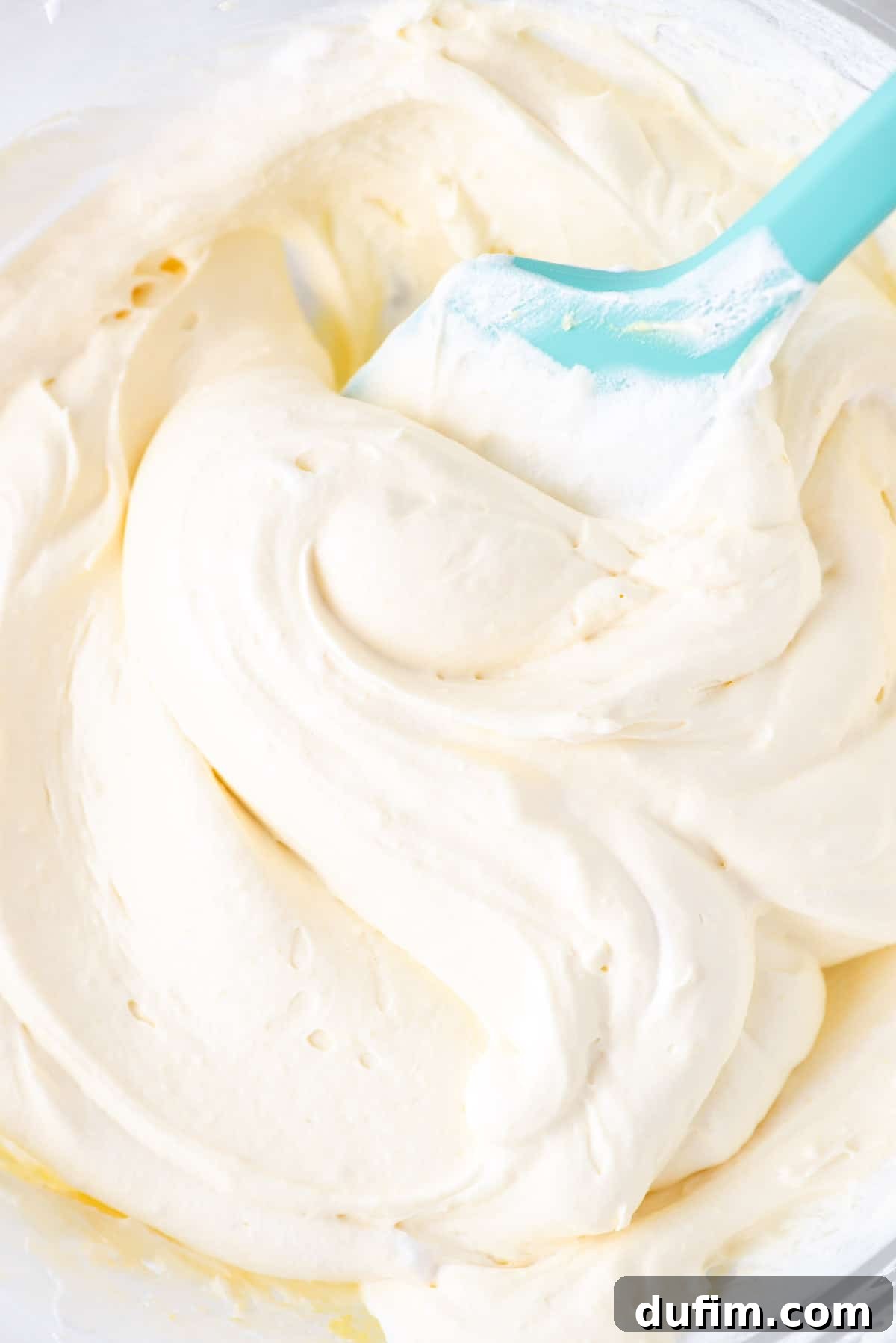close up of cool whip frosting with a teal spatula