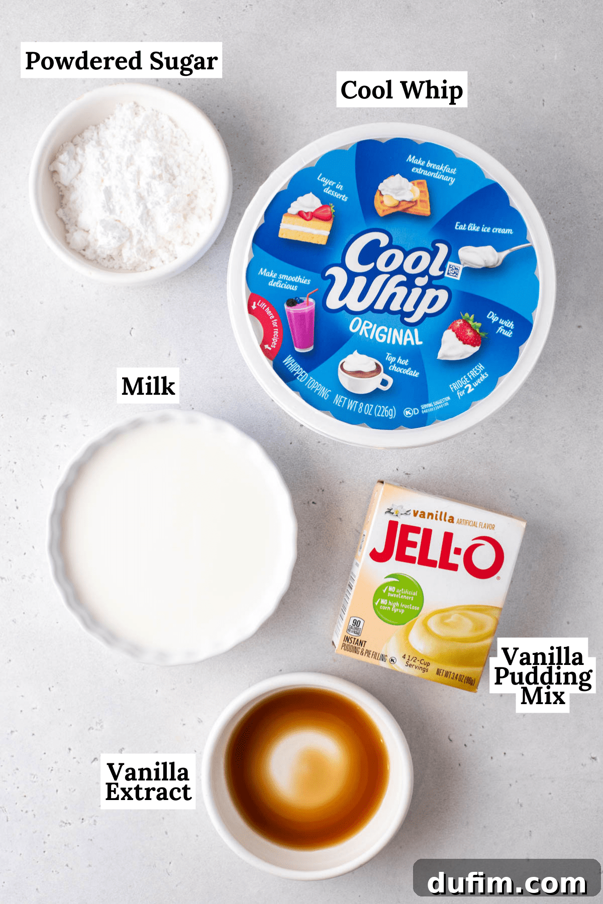 ingredients for cool whip frosting including vanilla extract, powdered sugar, a tub of cool whip, milk, and a box of vanilla pudding mix