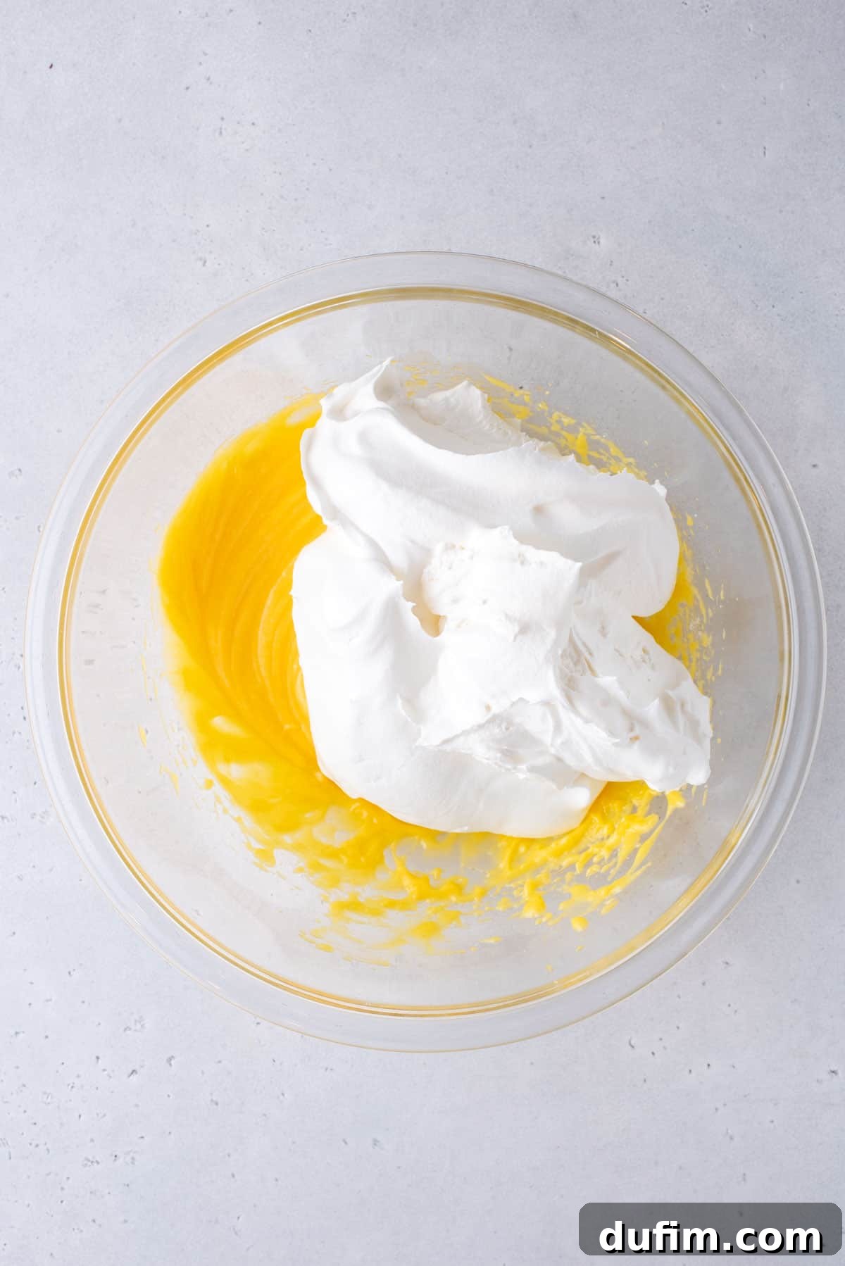 pudding mix, powdered sugar, vanilla extract,milk and cool whip in a glass mixing bowl