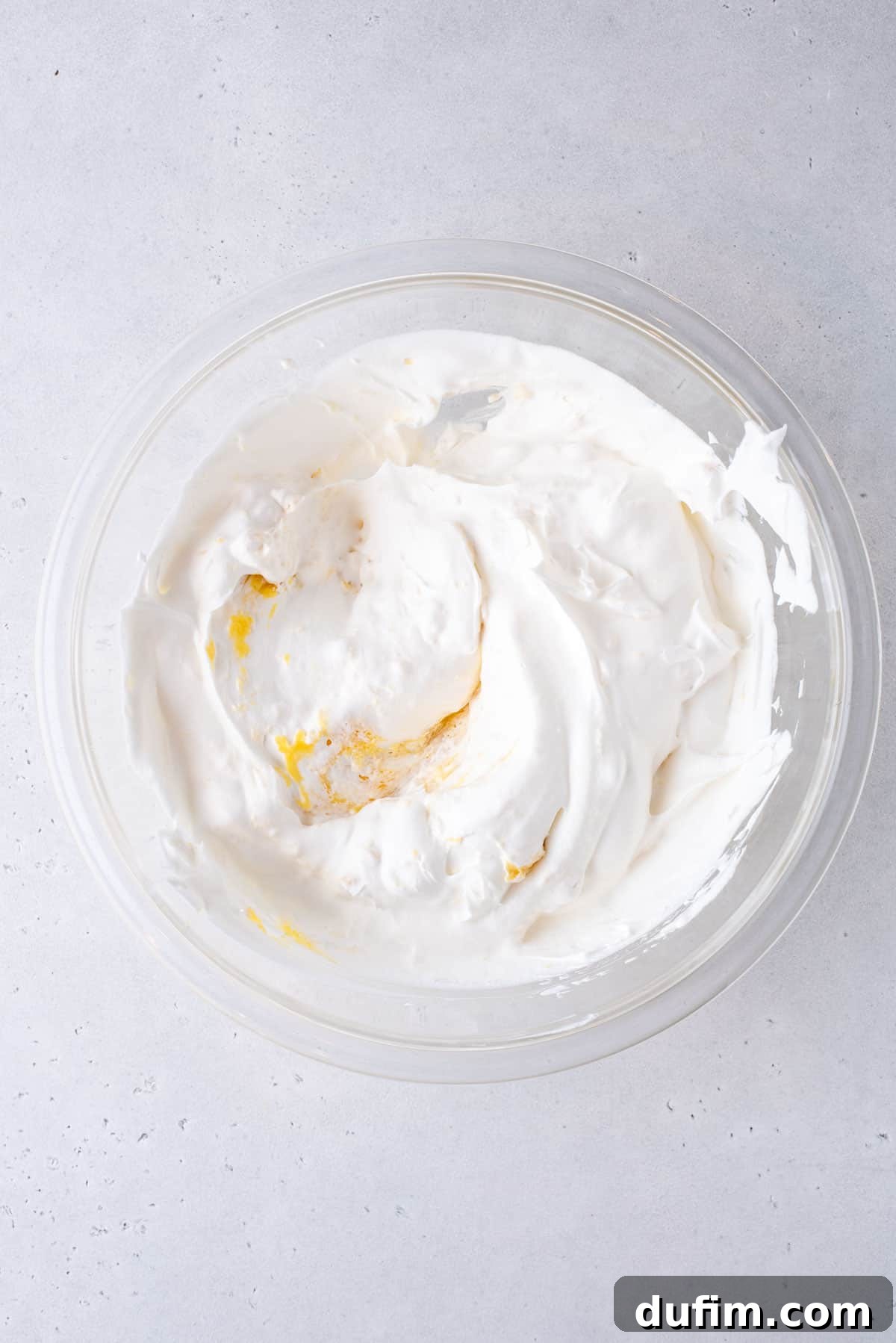 pudding mix, powdered sugar, vanilla extract,milk and cool whip combined in a glass mixing bowl
