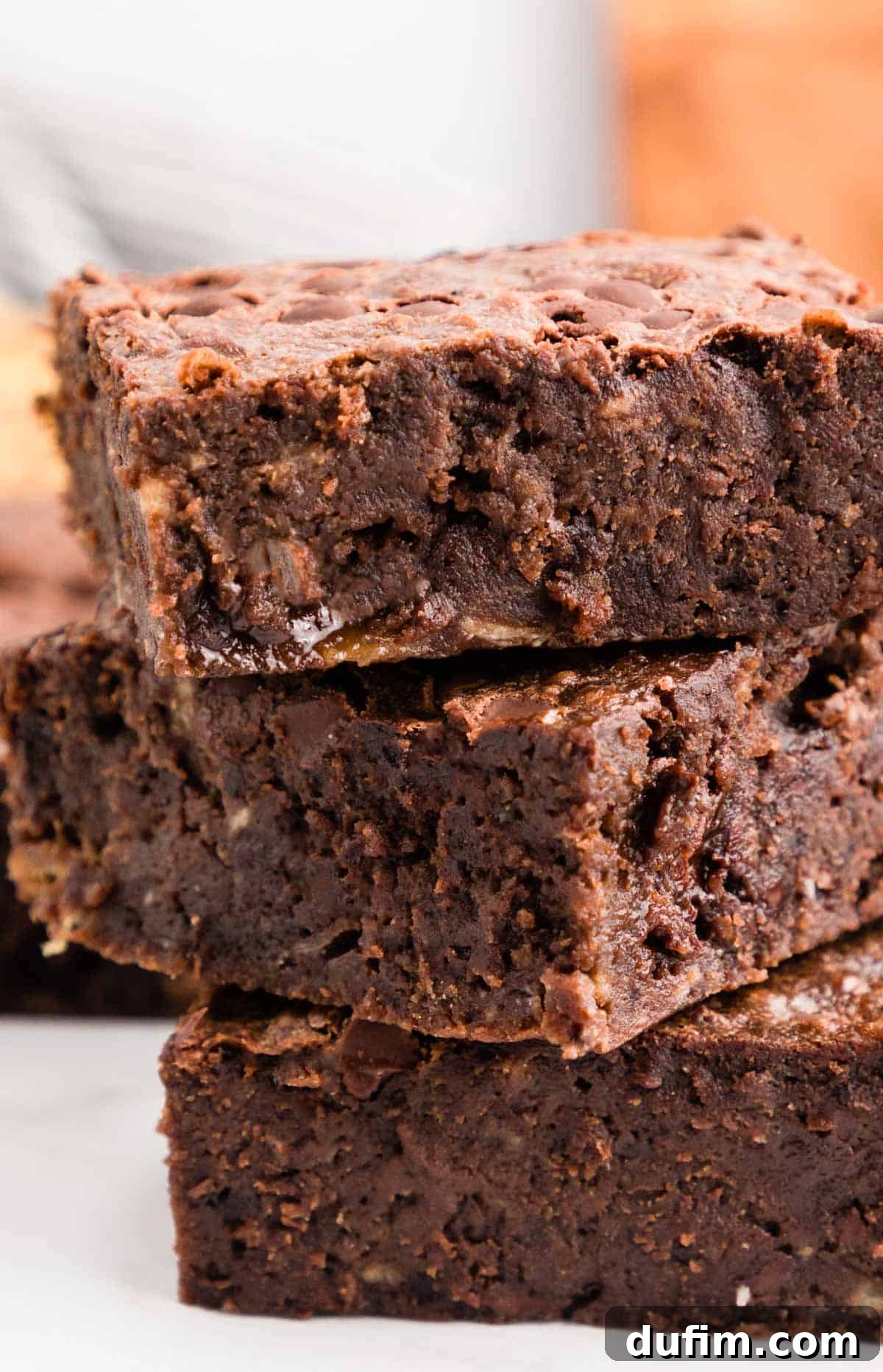 A perfectly stacked trio of fudgy banana brownies, showcasing their thick, rich texture and inviting appearance, ready to be enjoyed.