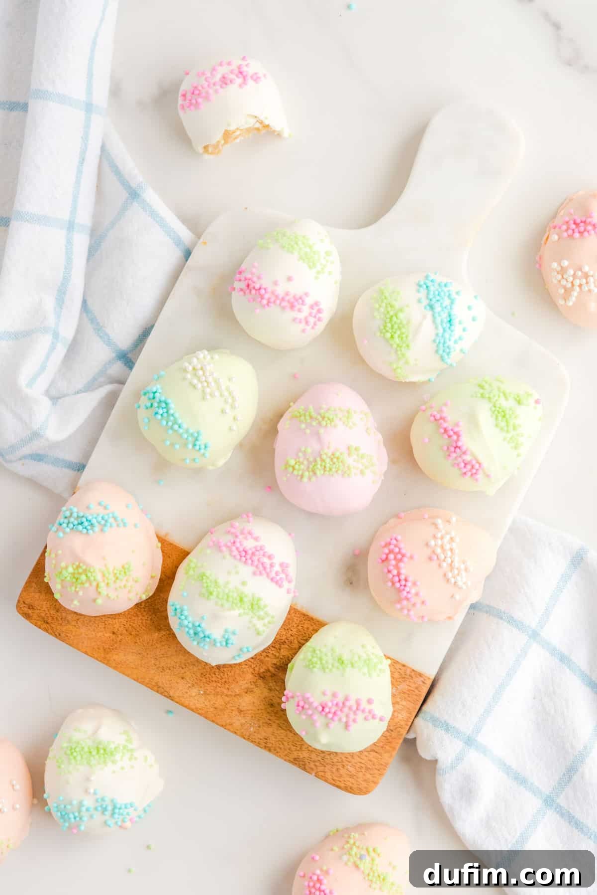 easter egg truffles arranged on and around a cutting board and a kitchen towel