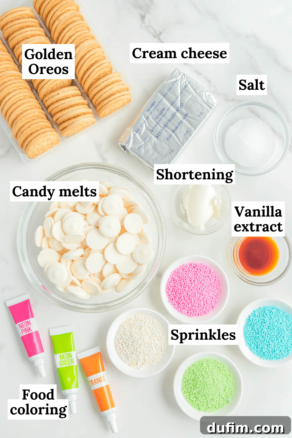 the ingredients for easter egg truffles arranged on a white background, including food coloring, pink, blue, white and green sprinkles, golden oreos, cream cheese, salt, vanilla extract, shortening, and white candy melts
