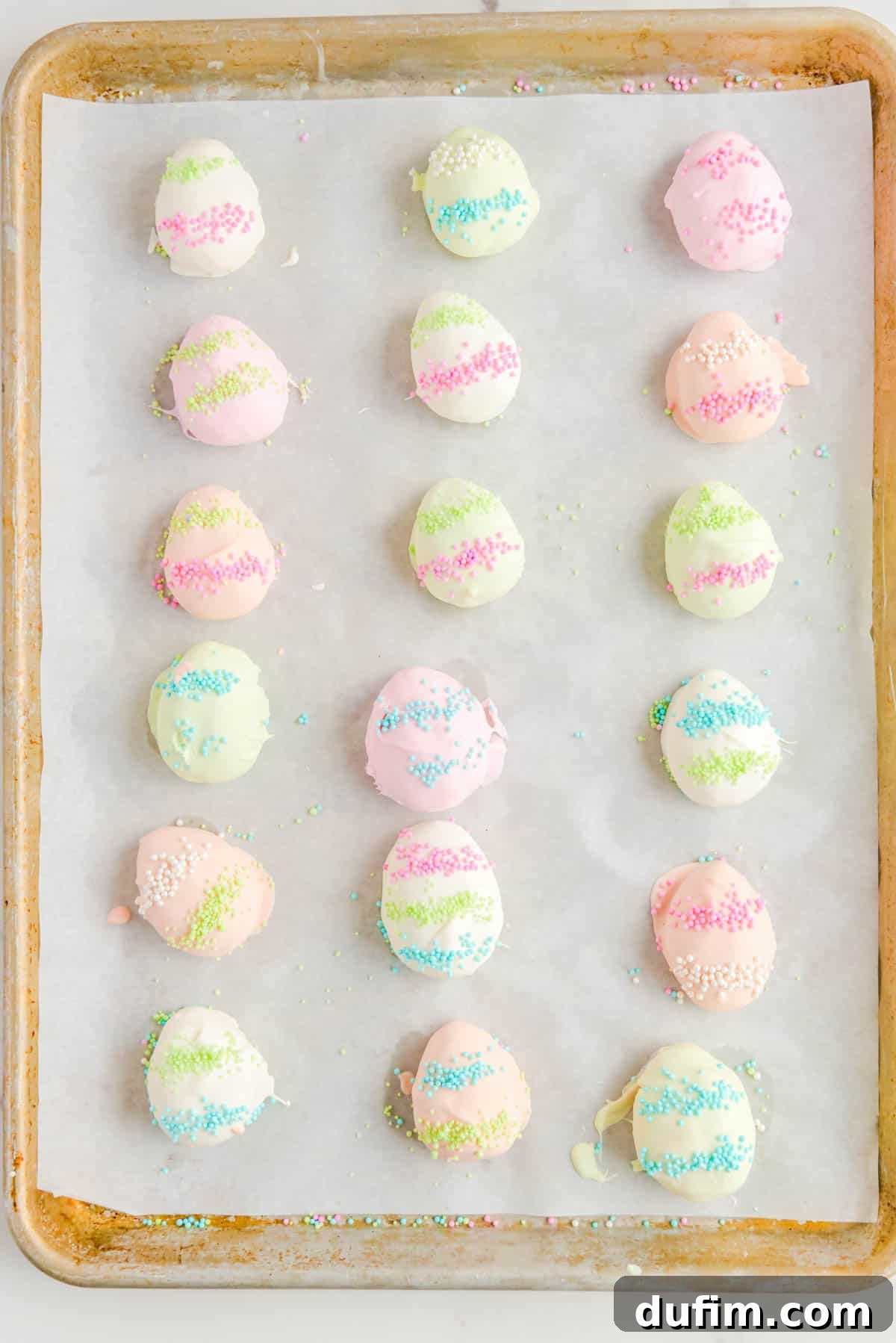 easter egg truffles lined in three columns on a baking sheet