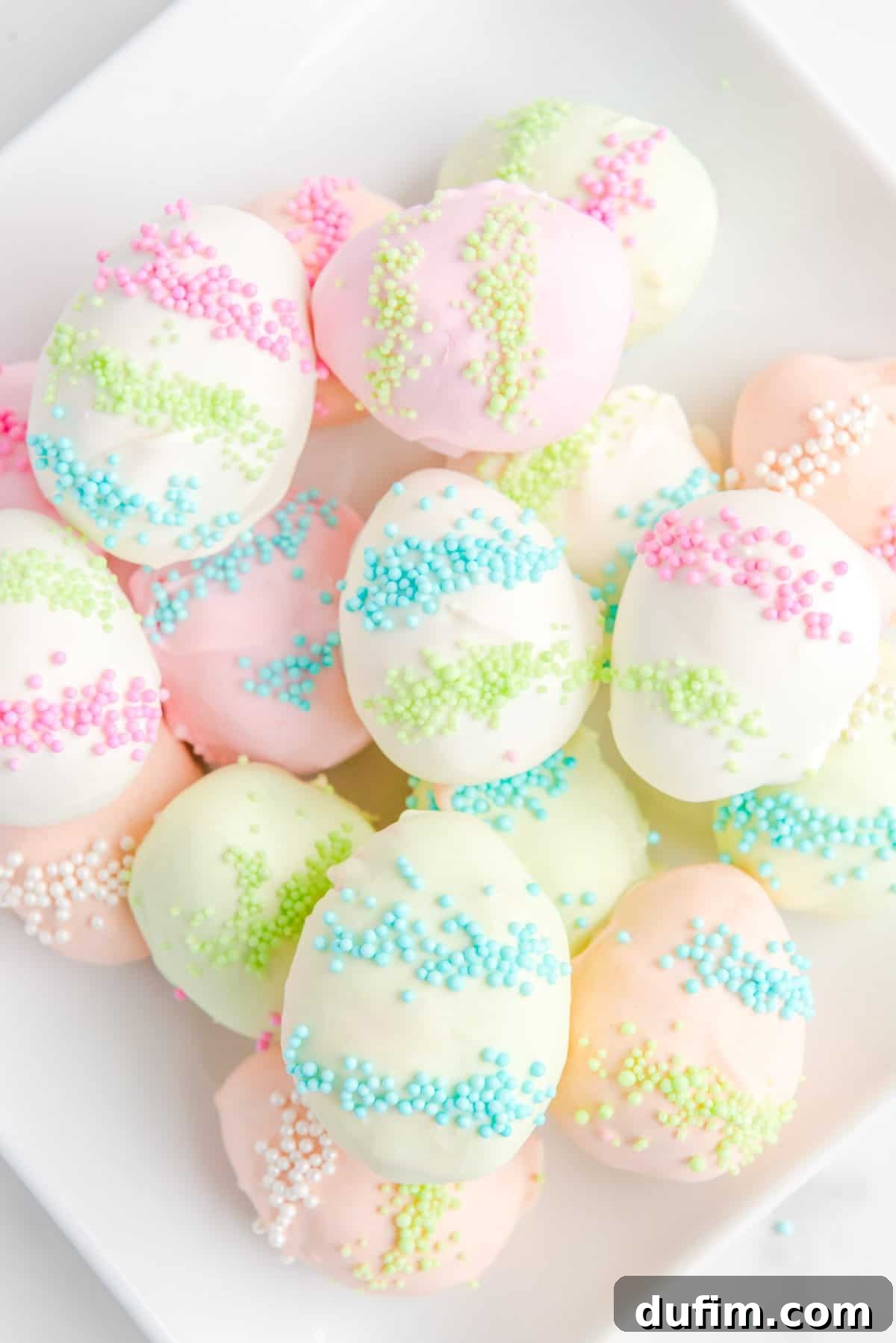 a pile of easter egg truffles on a white plate